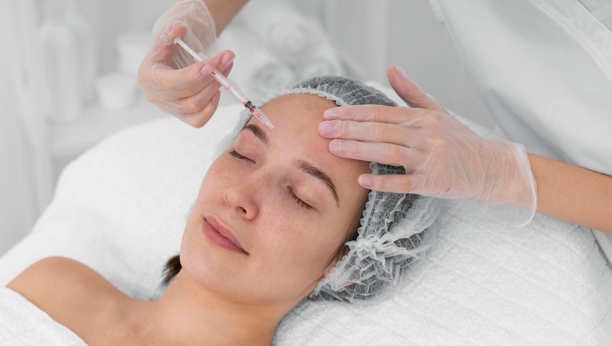 Provider administering a forehead injection